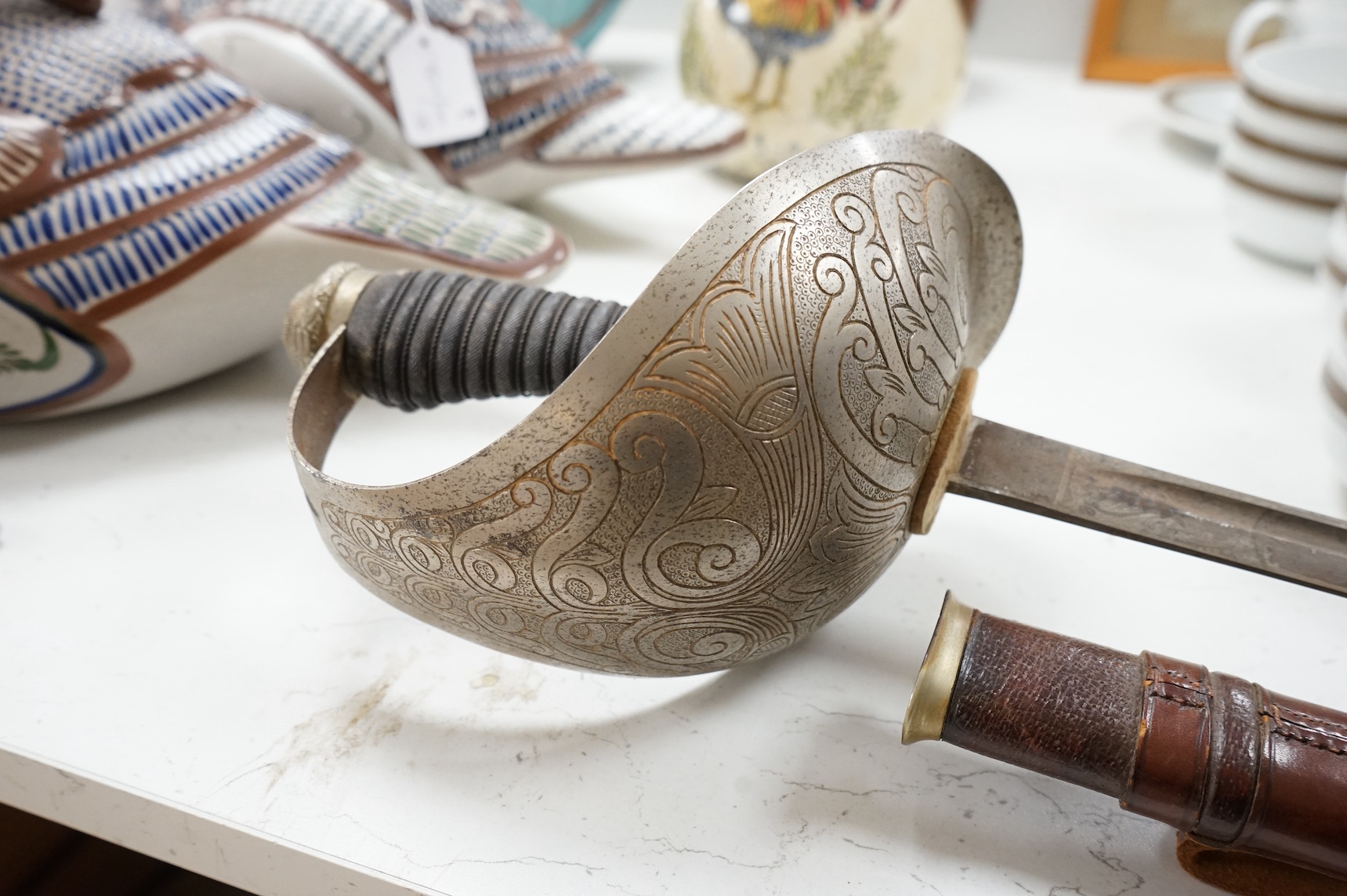 A 1911 pattern cavalry officer’s sword by J. Gaunt and son, etched with crowned GVR cipher and owner’s initials; HPH, regulation hilt and leather covered scabbard